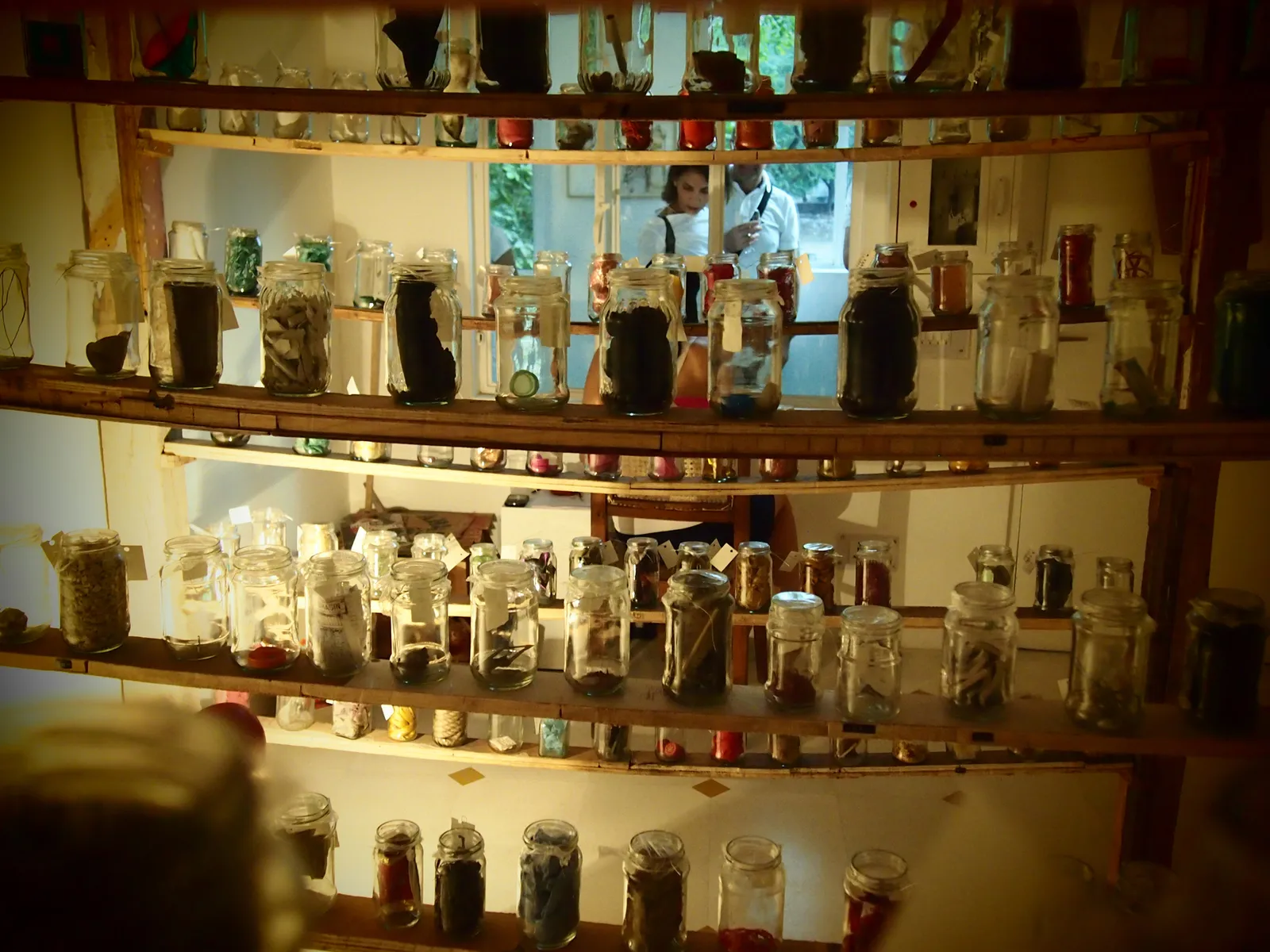 Odds and Ends, 2012 — the jars ranged along shelves built from salvaged wood, Delhi