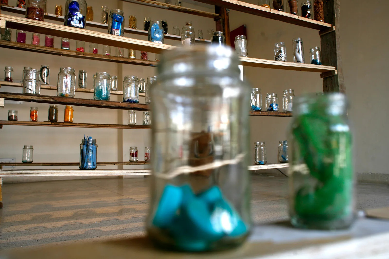 Odds and Ends, 2012 — two jars in the foreground, the shelves behind them out of focus