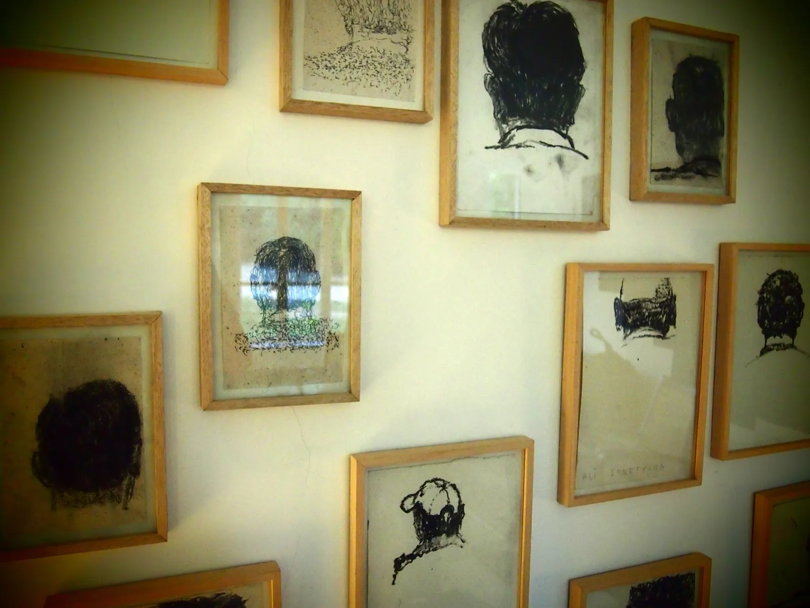 How Many Times? — framed charcoal heads (detail)